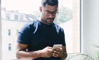 Man using phone in home
