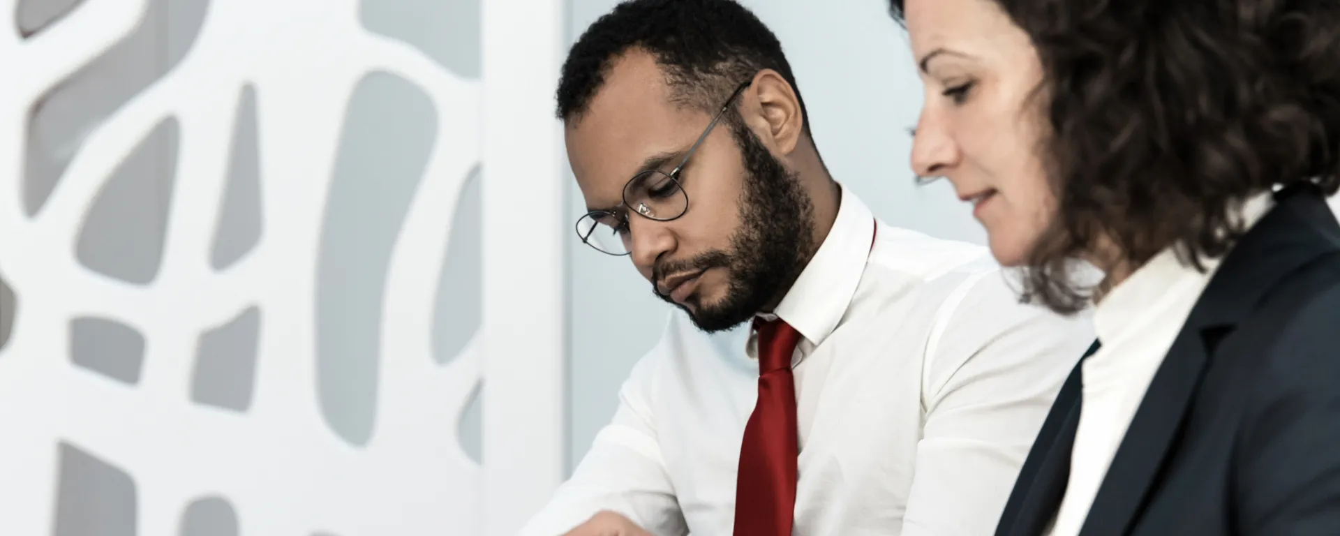 Two office employees studying during training