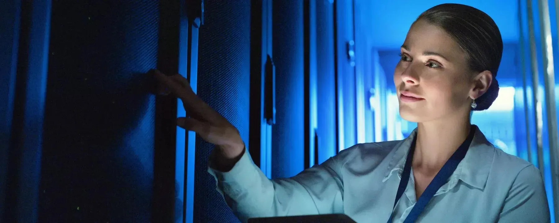 woman and technician working in server room 1490657099