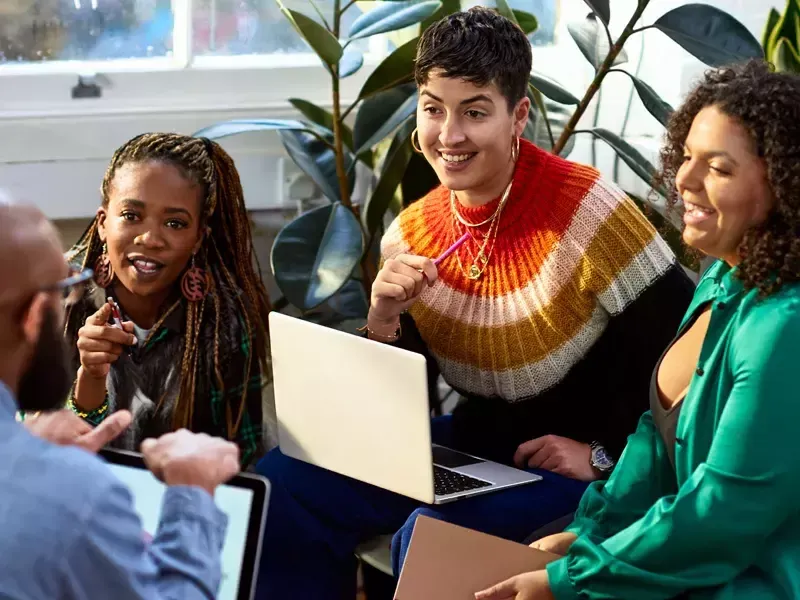 group-discussion-with-laptops-and-documents-in-office