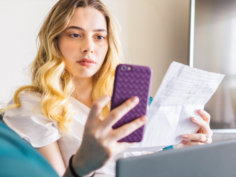 Woman using phone to pay bills
