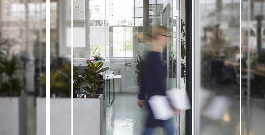 Blurred person walking through office