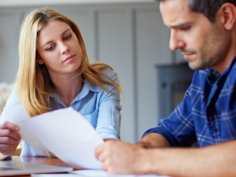 couple-looking-at-bills