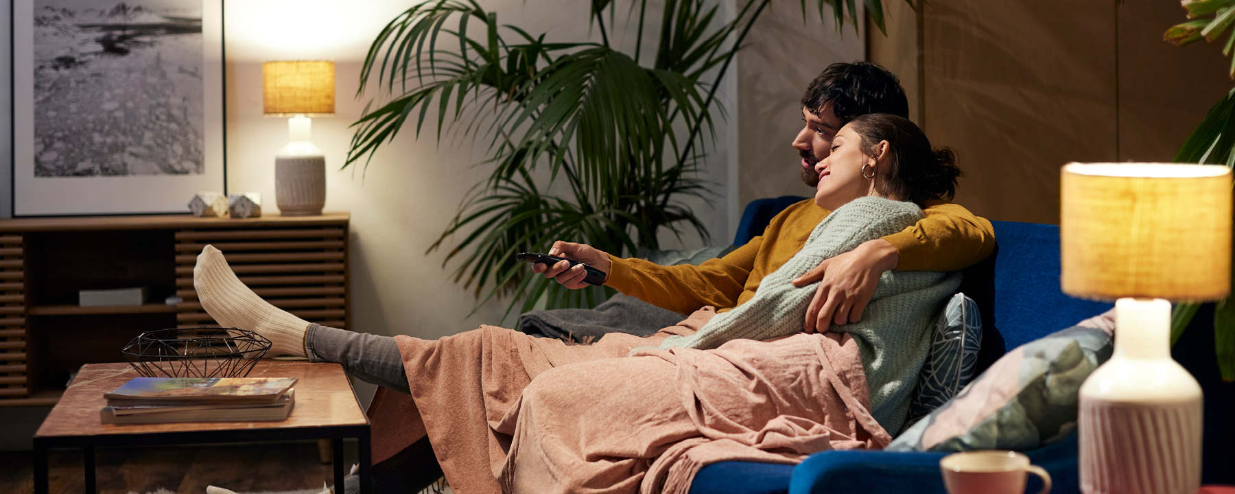 Mortgage - couple sitting on sofa watching Television