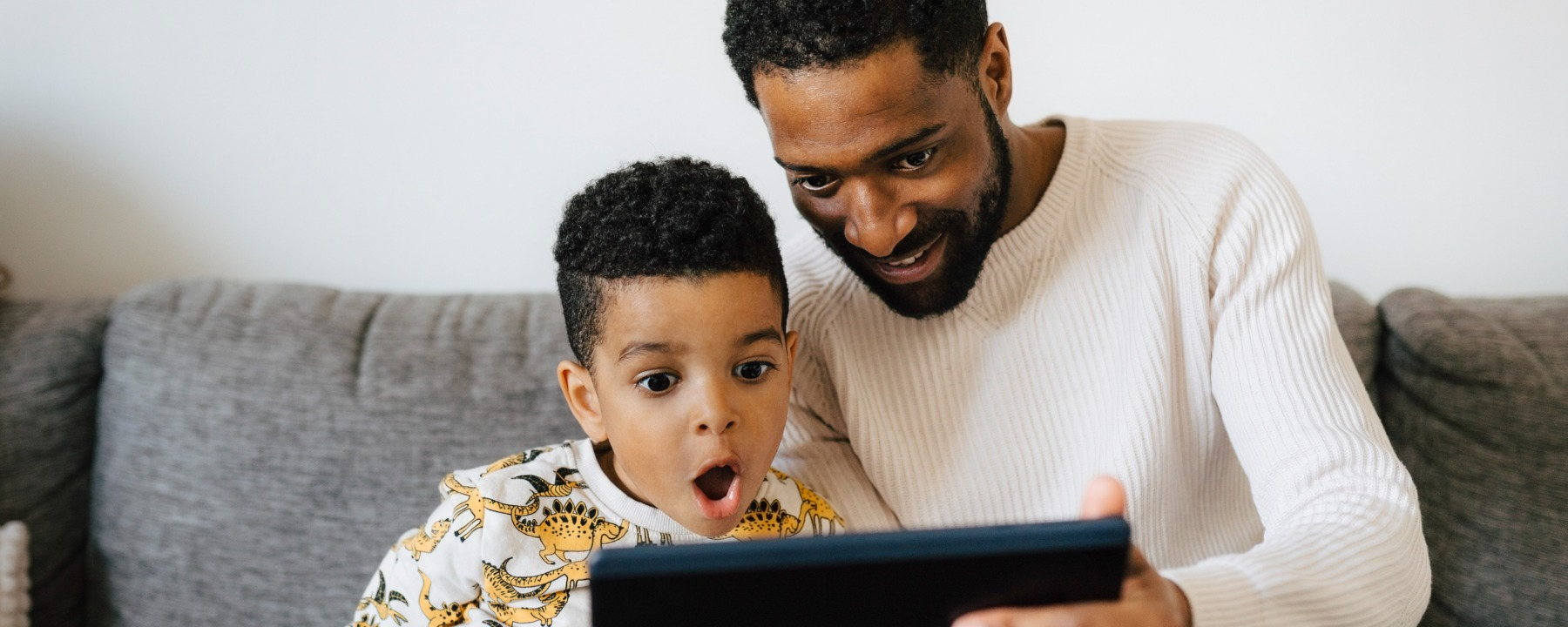 Technology -young boy looking at tablet with dad-1800*720