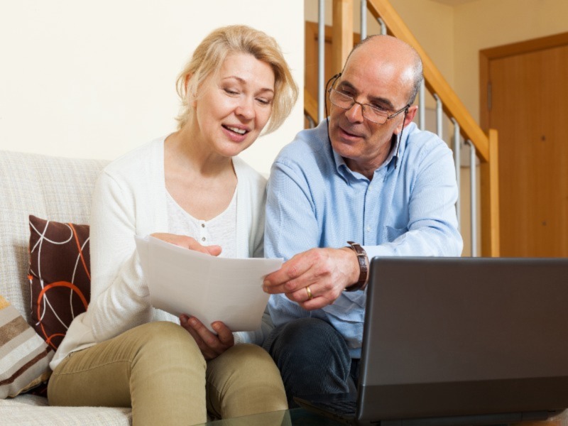Mature couple documents laptop