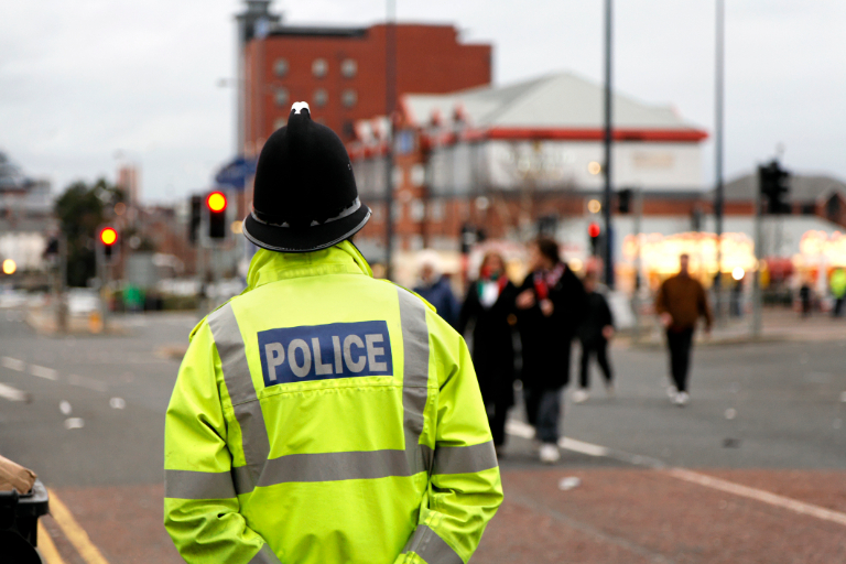Police man standing on street. Police man standing on street.