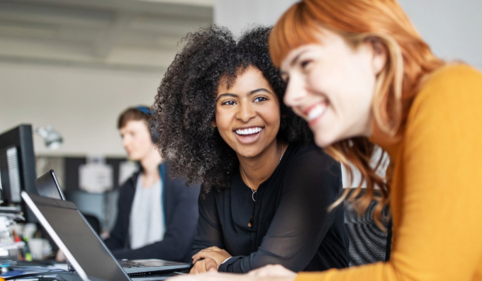 Two girls using laptop