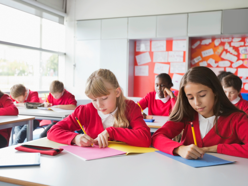 Students writing in classroom