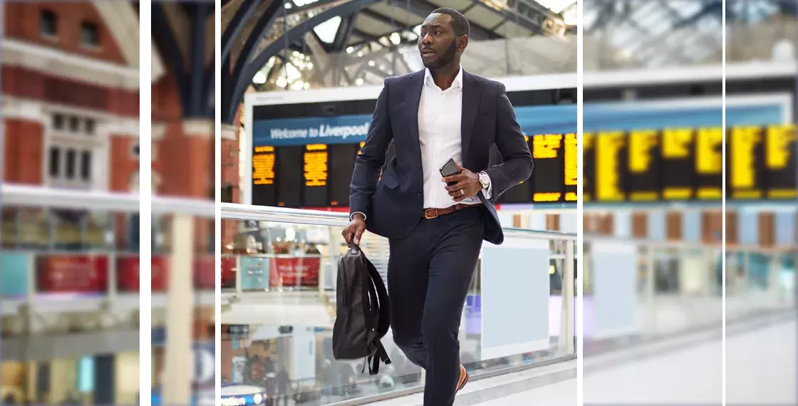 Businessman walking through train station