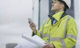 Construction worker on site with planning documents
