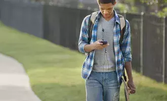 Male teenager walking through park