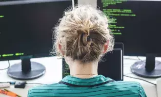 Female employee looking at code