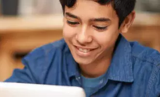 School boy using tablet device