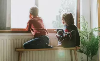 kids sitting near window