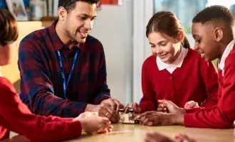 Children watching and listening to teacher in STEM clas