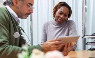 Female patient reviewing medical test results with her doctor