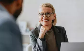 Happy Businesswoman in Office Meeting Discussion with Colleague