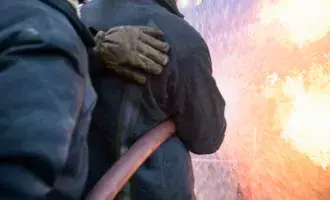 two-firefighters-putting-out-fire