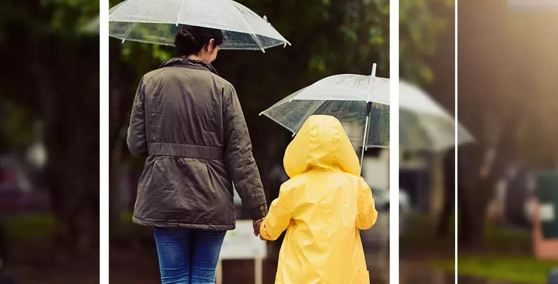 2 people walking with umbrellas