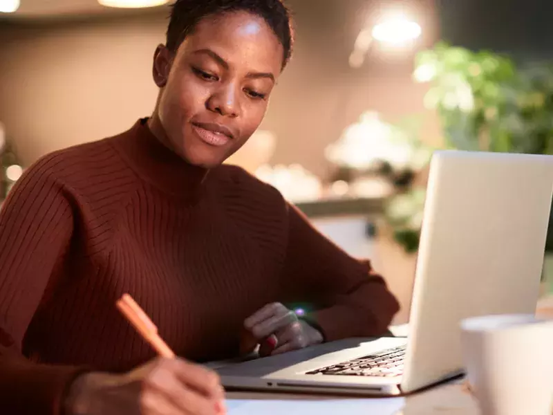 Learning & development Person writing on office desk