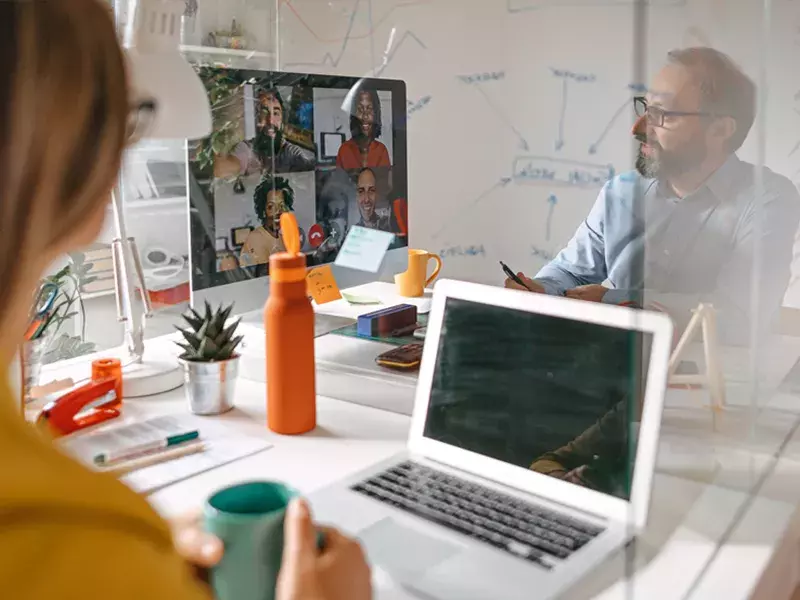 Capita Procurement transformation Person sitting at office desk with laptop