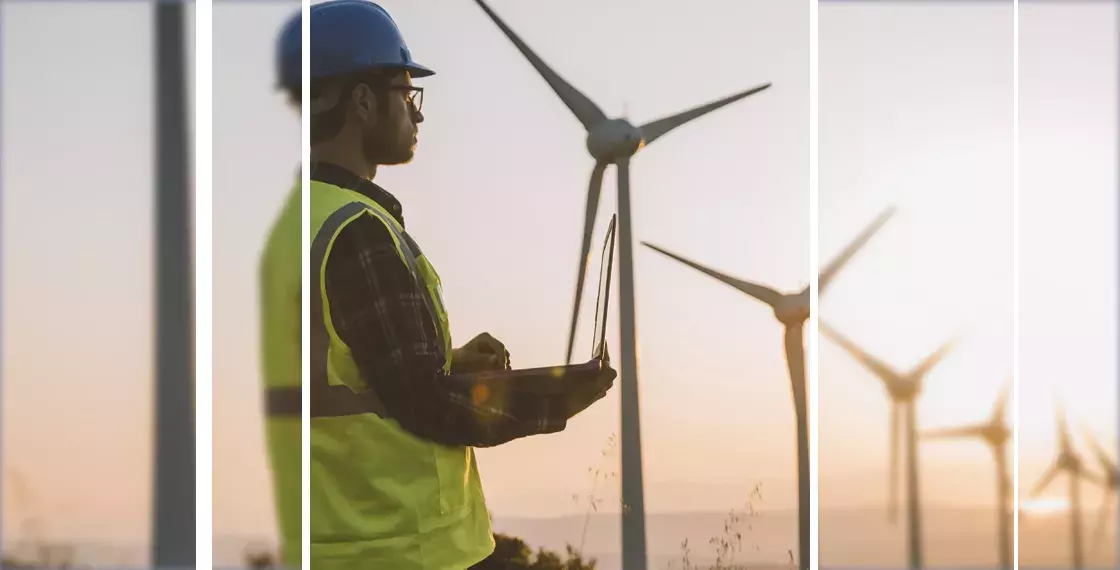 Capita Utility solutions Man standing near wind turbines