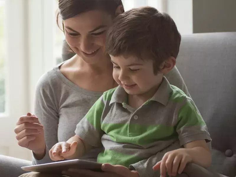 Mother and child looking at tablet device
