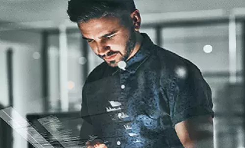 Why in invest in Capita | Capita investors Man looking at a tablet device