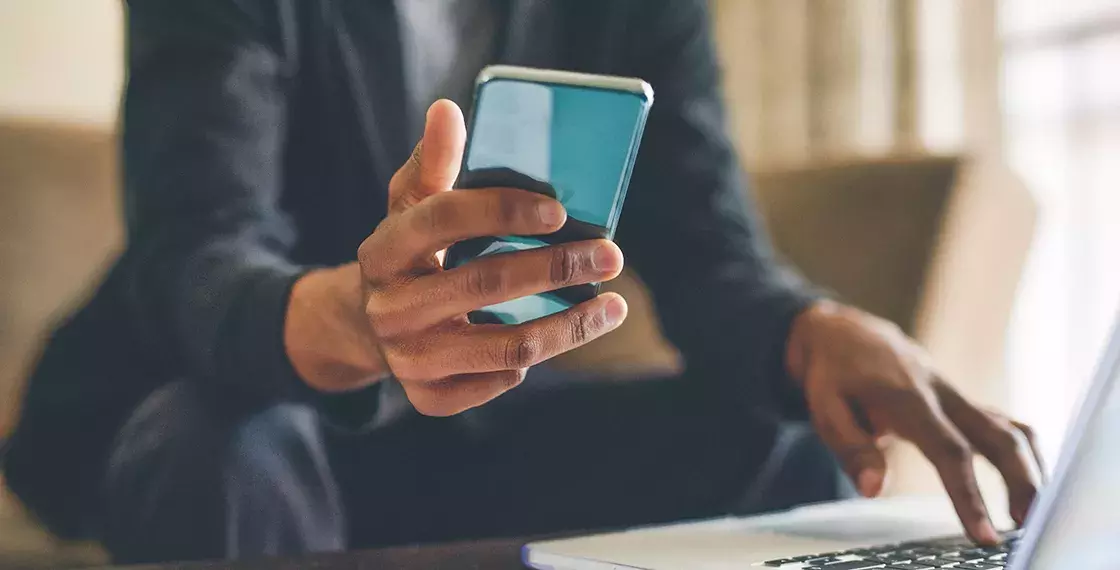 Capita Wealth management & investment banking Man holding smart phone