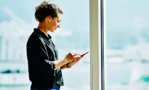 Corporate governance | Capita Women interacting with tablet device