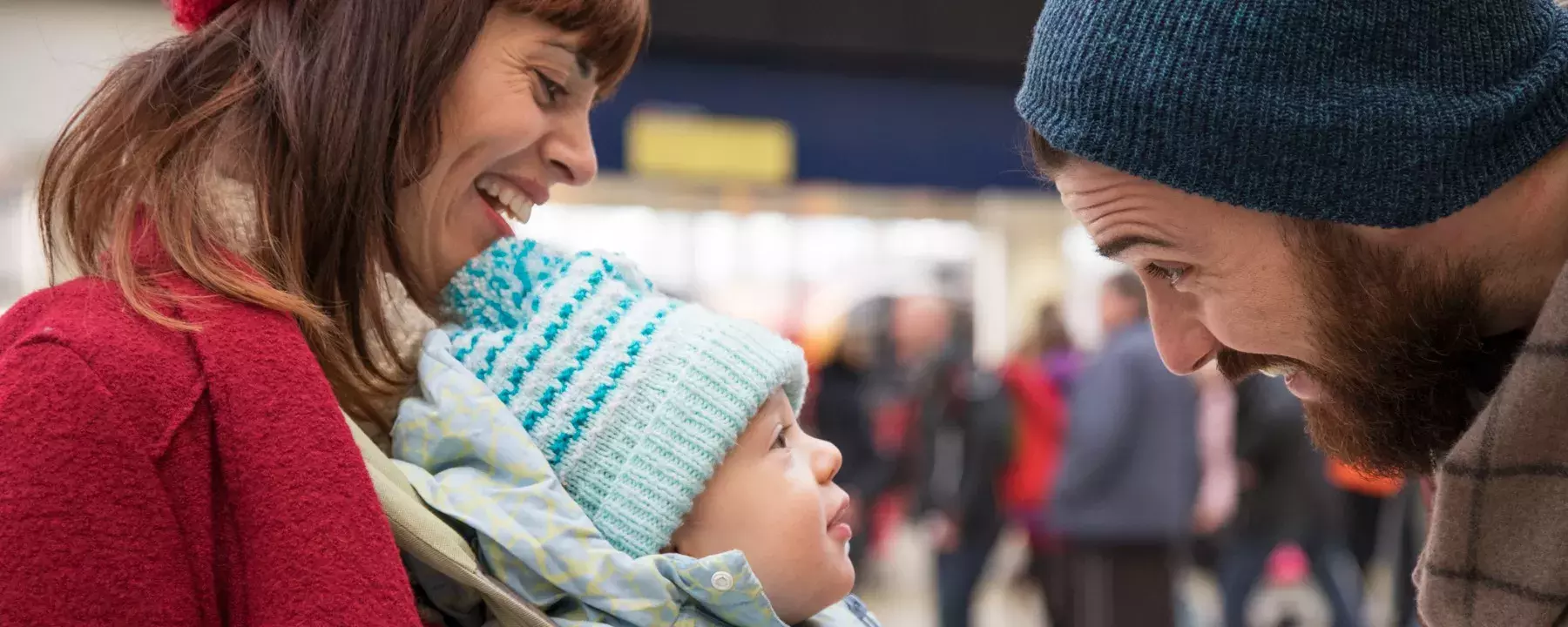 Customer experience - mum and dad with baby at train station - 1800x720