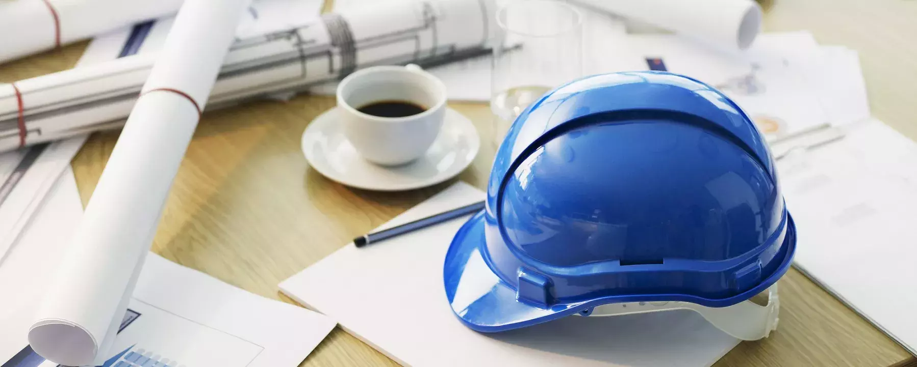 Plans and hard hat on a table