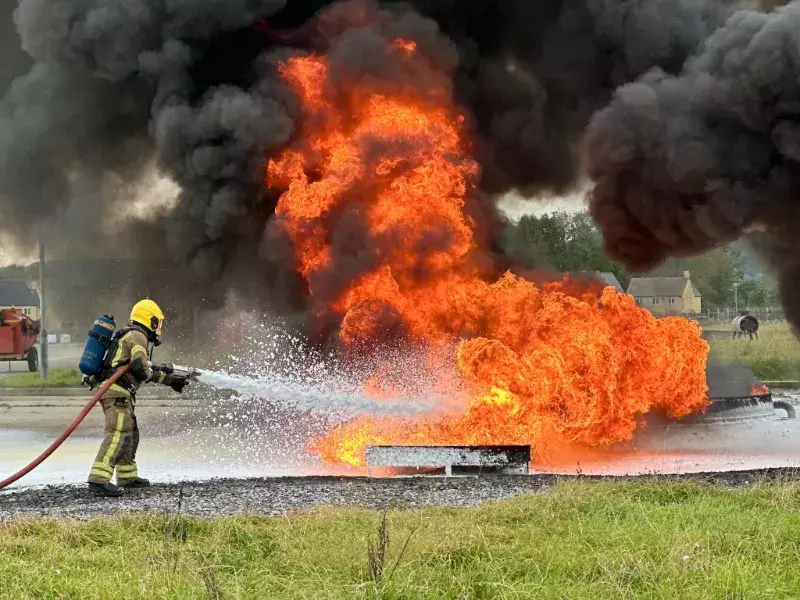  Firefighter extinguishing an industrial fire